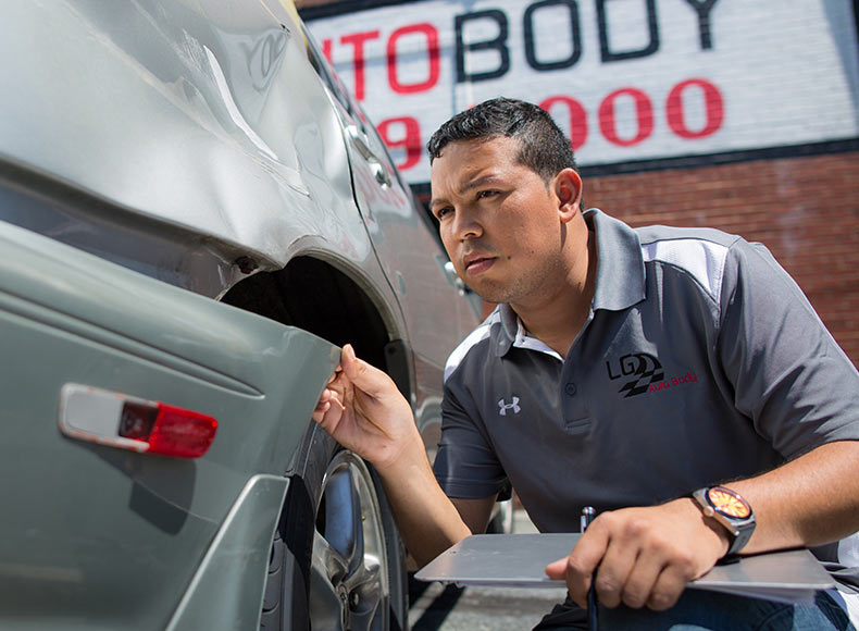auto body repair silver spring luis inspecting vehicle